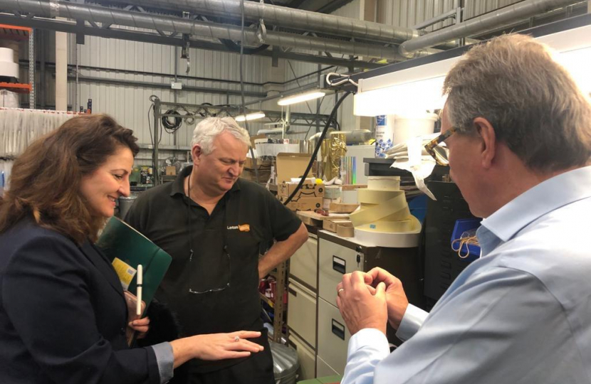 MP Caroline Ansell pictured inside the organisation alongside Lotus Label staff.