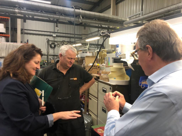 MP Caroline Ansell pictured inside the organisation alongside Lotus Label staff.