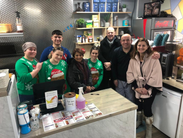 Caroline Ansell MP, Cllrs Kshama Shore and Nigel Goodyear inside Beatty Cafe, Beaty Rd. Pictured with staff in Christmas sweaters. Sovereign ward. 